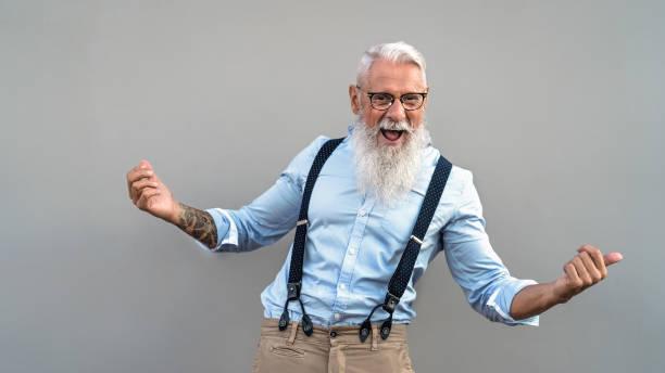 Happy senior man celebrating and laughing in front camera - Fashion elderly male lifestyle concept Happy senior man celebrating and laughing in front camera - Fashion elderly male lifestyle concept lively dancing stock pictures, royalty-free photos & images